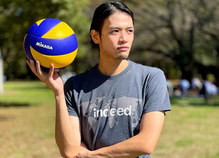 Indeedian holding volleyball